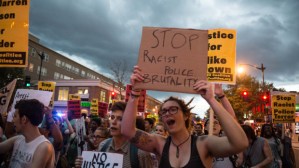 People march in Washington on September 6, 2014 to protest the killing of black teen Michael Brown whose killing by a white policeman in Ferguson, Missouri, ignited violent protests and debate on race and law enforcement in America.    AFP PHOTO/Nicholas KAMM        (Photo credit should read NICHOLAS KAMM/AFP/Getty Images)