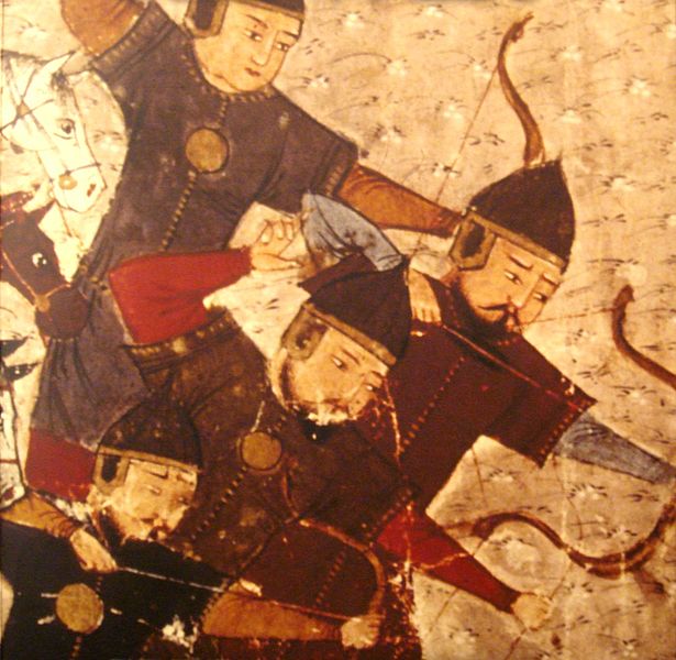 Four Asian archers in armor, all facing to one side as they fire arrows at an unseen enemy. 