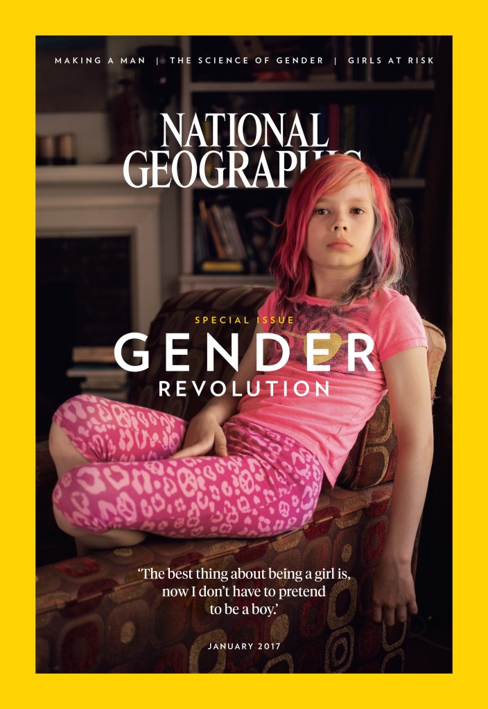 A National Geographic magazine cover with their standard wide yellow border and white lettering saying "NATIONAL GEOGRAPHIC." A nine-year-old girl with dyed pink, shoulder-length, side-parted hair and pale skin sits in a chair with one arm in her lap and one arm dangling off the chair to the side. She looks seriously into the camera. She's wearing pink flowered cropped pants and a pink t-shirt. Underneath her, in white lettering, it says, "The best thing about being a girl is, now I don't have to pretend to be a boy." Across the middle of the image, in white lettering, it says, "Special issue: Gender Revolution."
